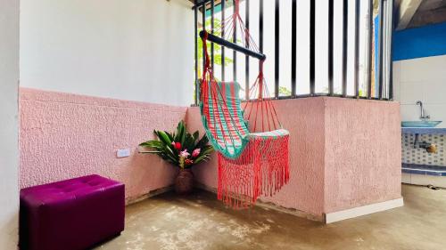 a balcony with a swing and a vase of flowers at Villa Luz Ovelia in El Valle