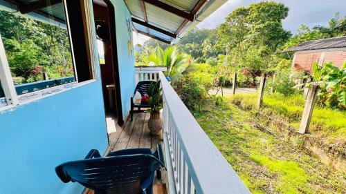 a porch with two chairs and a window at Villa Luz Ovelia in El Valle