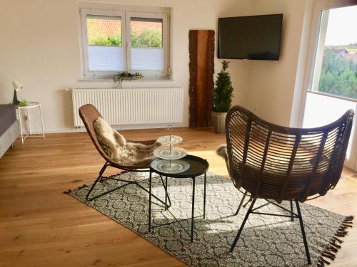 a living room with two chairs and a table at Tor ins Allgäu in Füramoos