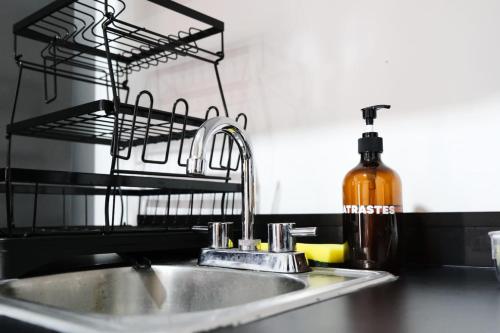 a kitchen sink with a soap dispenser next to it at Central and Comfortable 2BR1BA Work Here in Mazatlán