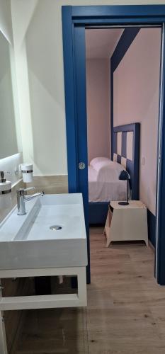 a bathroom with a sink and a bed in a room at marte rooms in Centola