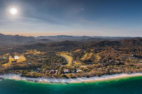 an aerial view of a beach and the ocean at Bougainvillea 3103 Luxury Apartment - Reserva Conchal in Playa Conchal
