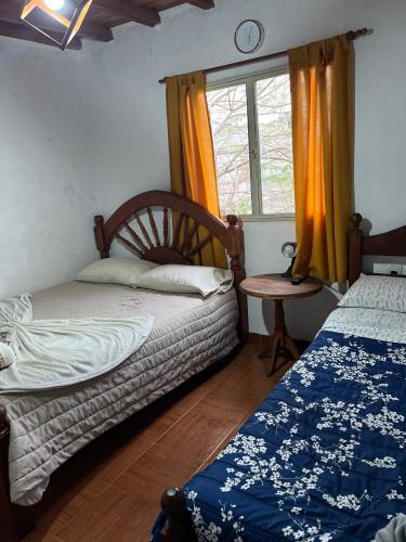 a bedroom with two beds and a window at Los Cactus Planta Alta in La Rioja