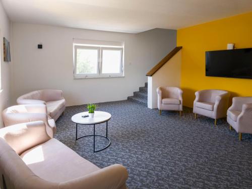 a living room with a couch and chairs and a tv at Motel Anić in Novi Travnik