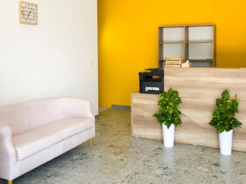 a living room with a couch and a mirror at Motel Anić in Novi Travnik