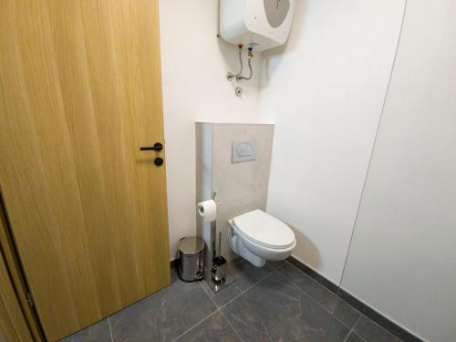 a small bathroom with a toilet and a door at Motel Anić in Novi Travnik