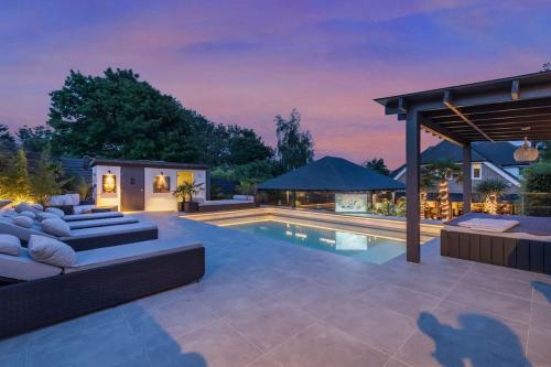a backyard with a swimming pool and a villa at Blissfully Luxe Abode for Unforgettable Memories in Brighton & Hove