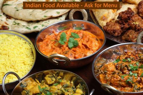 a table topped with different types of indian food available ask for menu at Sunny Island Cliff Side Views in Anacortes