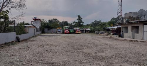 a dirt road with cars parked on the side at Hotel Villa Salomé LECP in Villagarzón