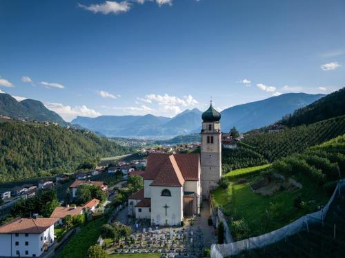 an aerial view of a small village with a church at Privatzimmervermietung Messner in Rifiano