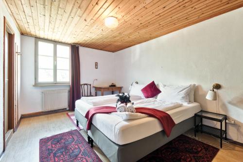 a bedroom with two beds and a wooden ceiling at Privatzimmervermietung Messner in Rifiano