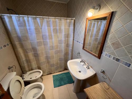 a bathroom with a toilet and a sink at Finca Los Arrieros - Malargüe in Malargüe