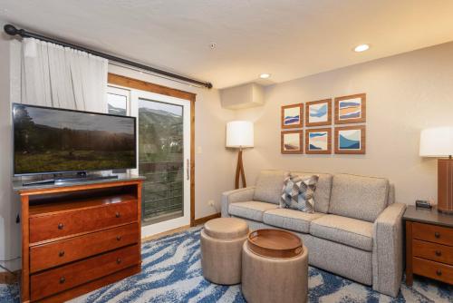 a living room with a couch and a television at NEW! Marriott Slope View Ski in Ski out Luxury Studio Sleeps 4 Full kitchen, Amenities & Fee Parking in Breckenridge