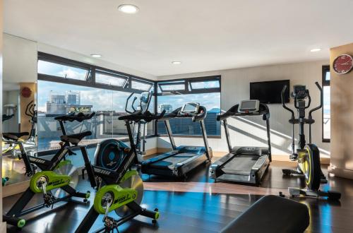 a gym with treadmills and cardio equipment in a building at Novotel Bogota Parque 93 in Bogotá