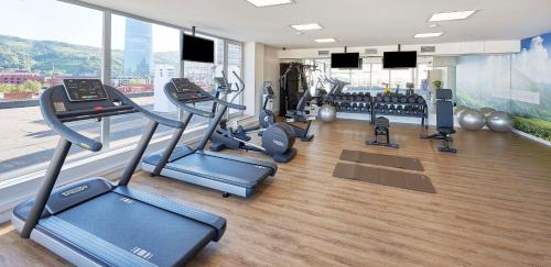 a gym with treadmills and cardio equipment in a building at NH Collection Villa de Bilbao in Bilbao
