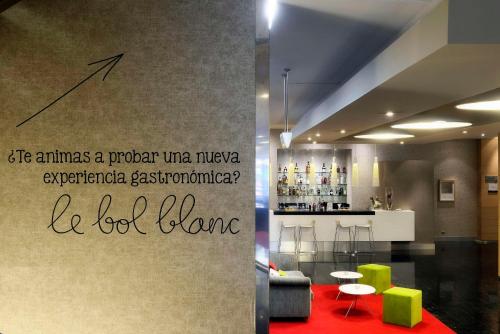 a picture of a living room with a bar at NH Collection Villa de Bilbao in Bilbao