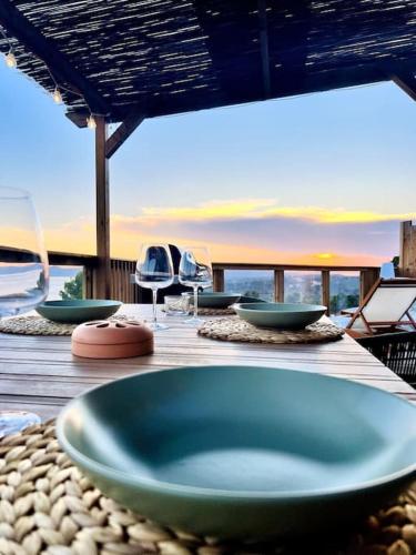 a wooden table with a blue bowl on top of it at Mobil home vue exceptionnelle et spa - Domaine de l'Ile d'Or in Saint-Raphaël