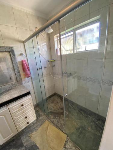 a bathroom with a shower with a glass shower stall at República Os Bartira in Ouro Preto