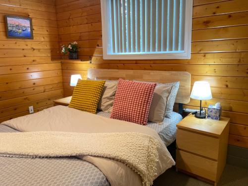 a bedroom with a bed with pillows on it at Whispering Pines Farmhouse in Redmond