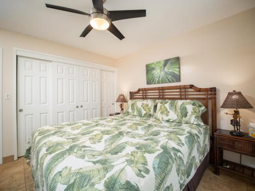 a bedroom with a bed and a ceiling fan at WBH D116 Aloha Wai - Garden Suite Just Steps from the Sea in Kihei