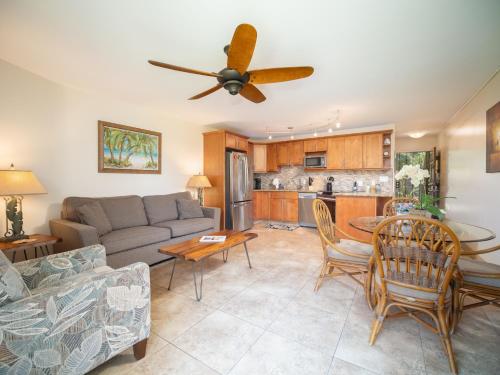 a living room with a couch and a table at WBH D116 Aloha Wai - Garden Suite Just Steps from the Sea in Kihei