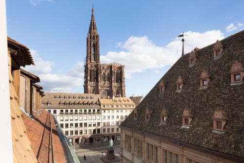 a view of a cathedral from the roofs of buildings at Hôtel Gutenberg in Strasbourg