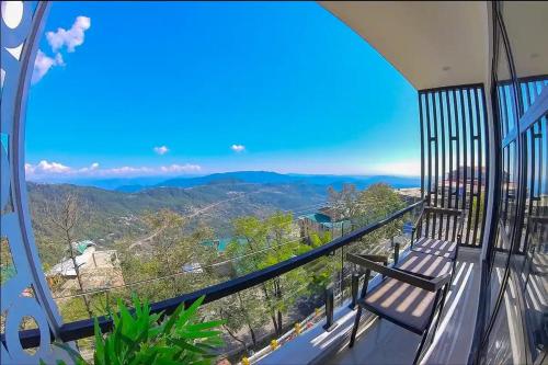 a balcony with a view of the mountains at Fiora Hotel in Murree