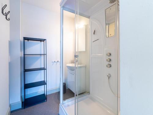 a glass shower in a bathroom with a toilet at Het Bruegelhof in Grote-Brogel