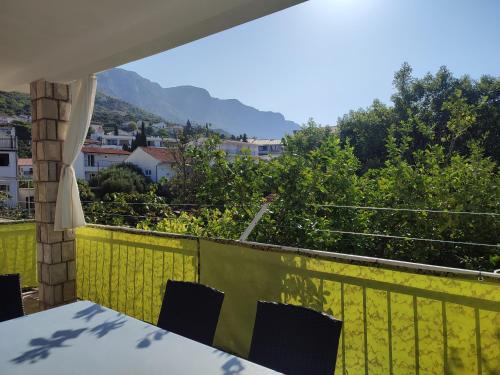 a table and chairs on a balcony with a view at Apartment Podaca 2576a in Podaca