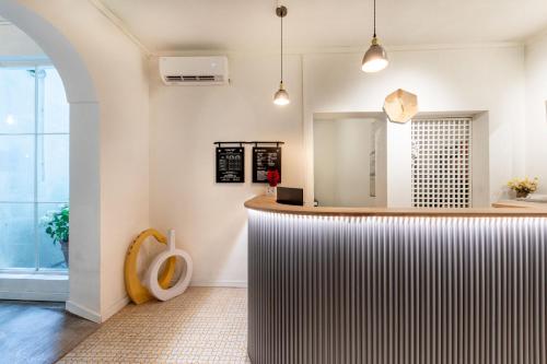 a bar with a wooden counter in a room at Shenzhen Loft Youth Hostel in Shenzhen