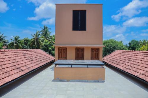 a building with a clock tower on top of a roof at The Mango Nest in Jaffna
