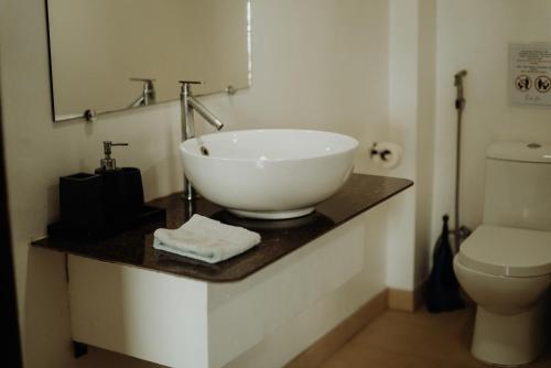 a bathroom with a sink and a toilet at Fantasy Lodge in Samboan
