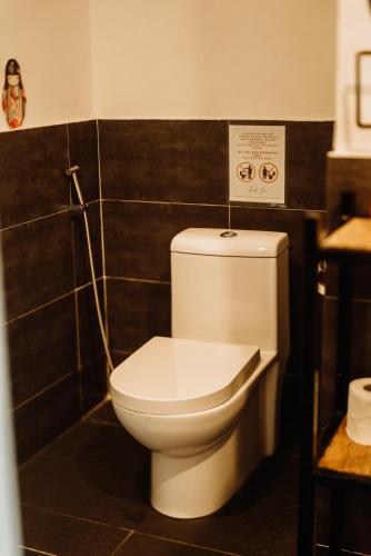a bathroom with a white toilet in a room at Fantasy Lodge in Samboan