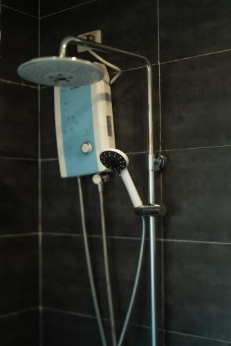 a shower with a hair dryer in a bathroom at Fantasy Lodge in Samboan