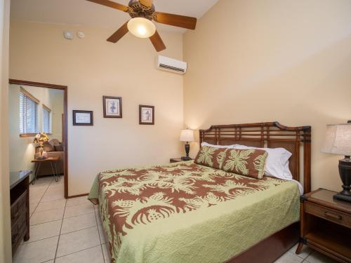a bedroom with a bed and a ceiling fan at Aloha Aku Ohana Suite - Spacious Garden View Oasis in Kihei