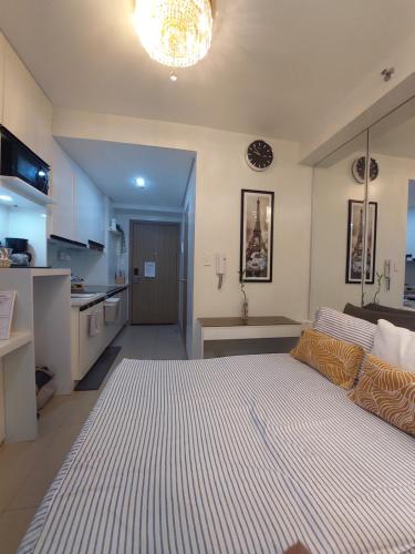 a large bedroom with a large bed and a kitchen at Overnight @ Shakhbot's in Manila