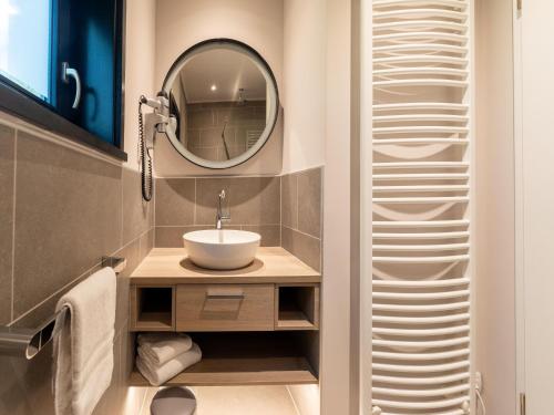 a bathroom with a sink and a mirror at Elegant Mansion with Pools in Antoing