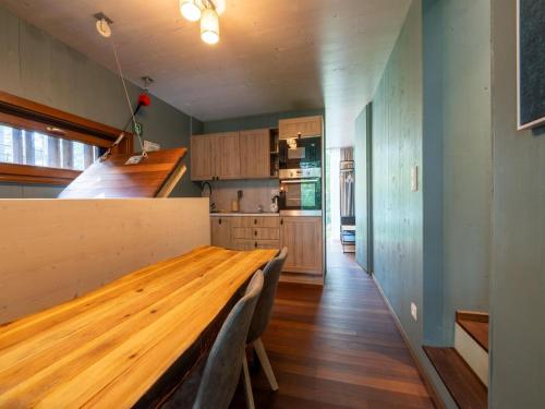 a kitchen with a wooden table in a room at Stylish Loft with Sauna in Antoing