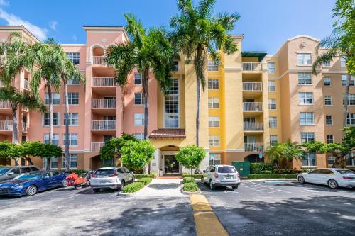 a parking lot with cars parked in front of a building at Luxury 3 Bds in Aventura Yacht club in Aventura