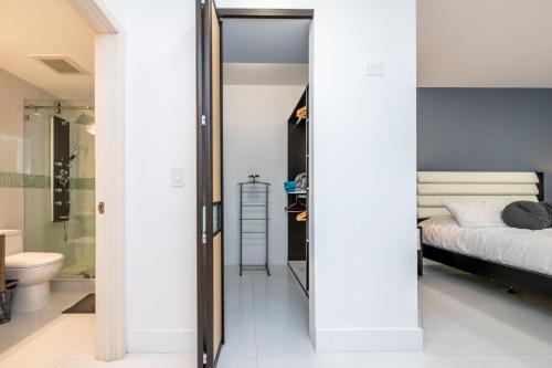 a bedroom with a bed and a glass door leading to a bathroom at Luxury 3 Bds in Aventura Yacht club in Aventura