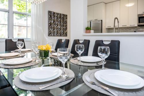 a dining room with a glass table with wine glasses at Luxury 3 Bds in Aventura Yacht club in Aventura