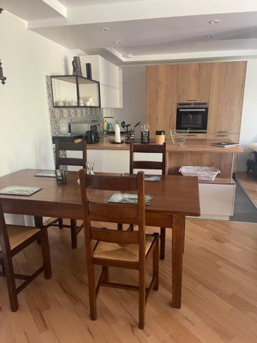 a kitchen with a wooden dining room table and chairs at Moderne, ruhige Ferienwohnung , ideal zum Abschalten in Hadamar