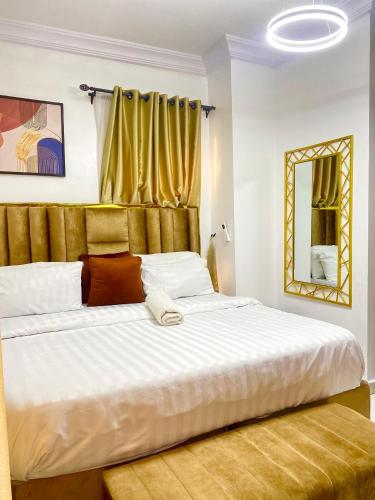 a large white bed in a room with a window at Affordable Modern 2 bedroom Luxury in Lekki Phase 1