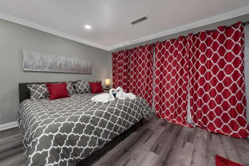 a bedroom with a bed and a red wall at Urban Retreat 1BR with Free Park in Houston