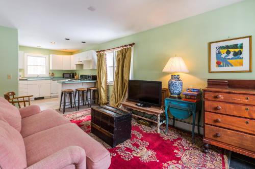 a living room with a couch and a tv at Private Tavern, Hot Tub, 8-Fireplaces, Spa Baths, Fire Pit, Baths Ensuite - Shop or Ski! in Landgrove Town Center