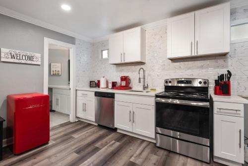 a kitchen with white cabinets and a black stove at Urban Retreat 1BR with Free Park in Houston