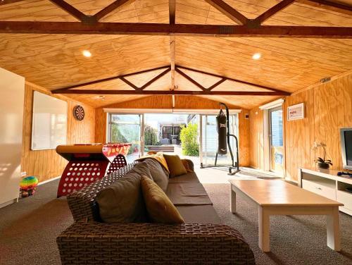 a living room with a couch and a table at Private Family City Retreat, Sleeps 8 in Christchurch