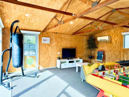 a living room with a couch and a tv at Private Family City Retreat, Sleeps 8 in Christchurch