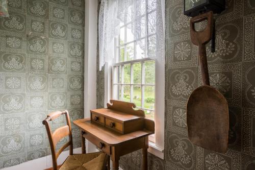a wooden desk in a room with a window at Fireplace, Ski-Okemo, Apple Trees, Piano, Amazing Views, Firepit, Priory, Pool, Fields, Theatre! in Weston