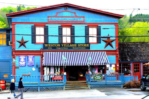 a building that is painted blue and red at Fireplace, Ski-Okemo, Apple Trees, Piano, Amazing Views, Firepit, Priory, Pool, Fields, Theatre! in Weston